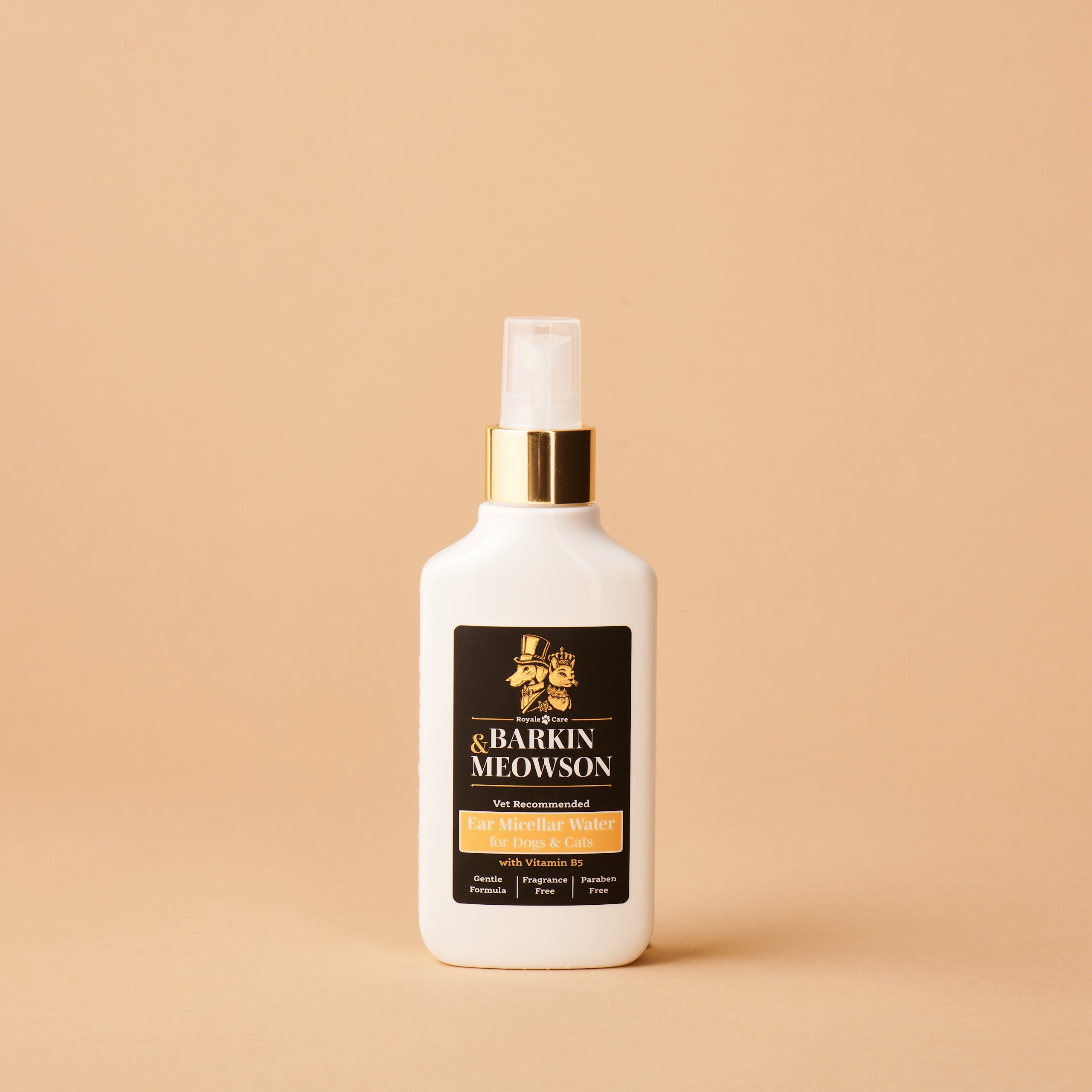 White bottle with gold cap on a beige background