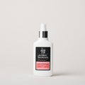 White bottle with a black label on a light gray background