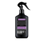 Black detangling spray bottle with purple label on a white background